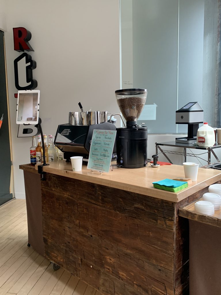 La Vita Espresso coffee cart setup with grinder, espresso machine, and Ripples latte art printer in a Minneapolis studio space.